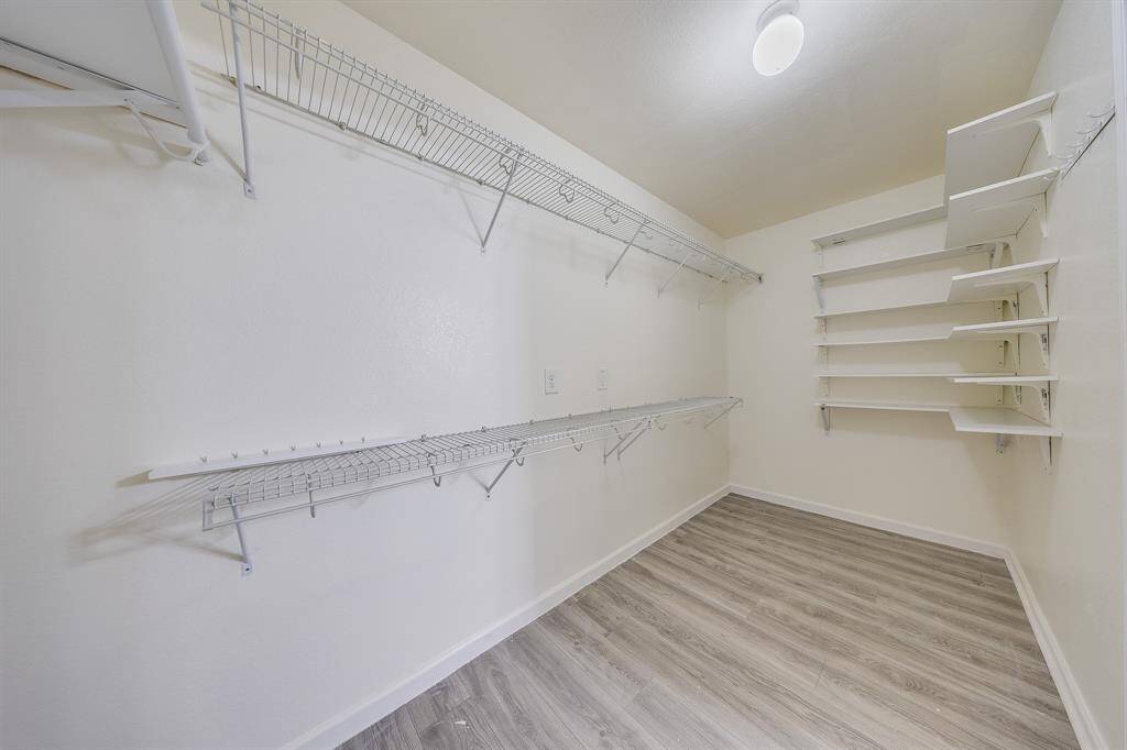 Spacious walk-in closet offers ample storage and organization for clothing and accessories.