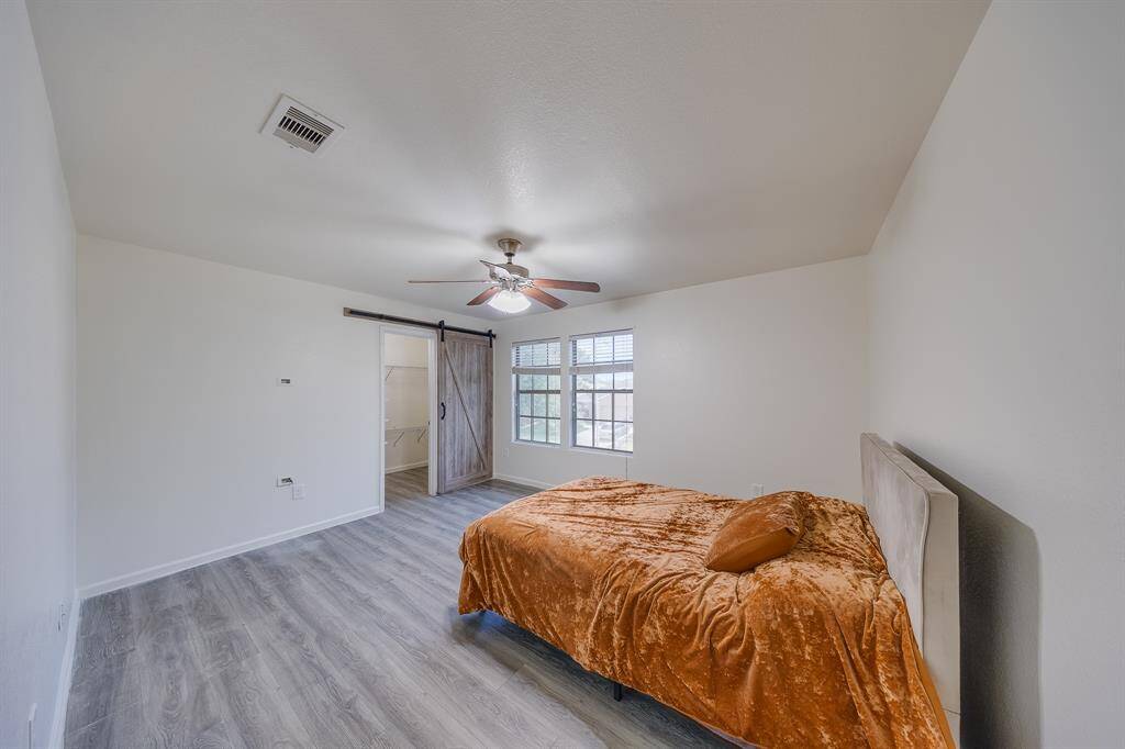 Upstairs bedroom #2 includes a spacious walk-in closet for convenient storage and organization.