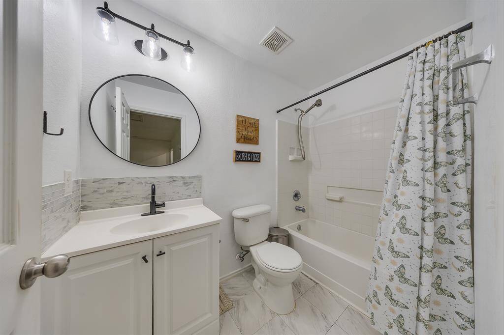 Second bathroom features stylish white and black details for a clean, modern look.