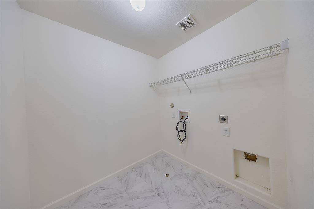 Utility room offers practical space for laundry and storage, keeping household tasks organized and efficient.
