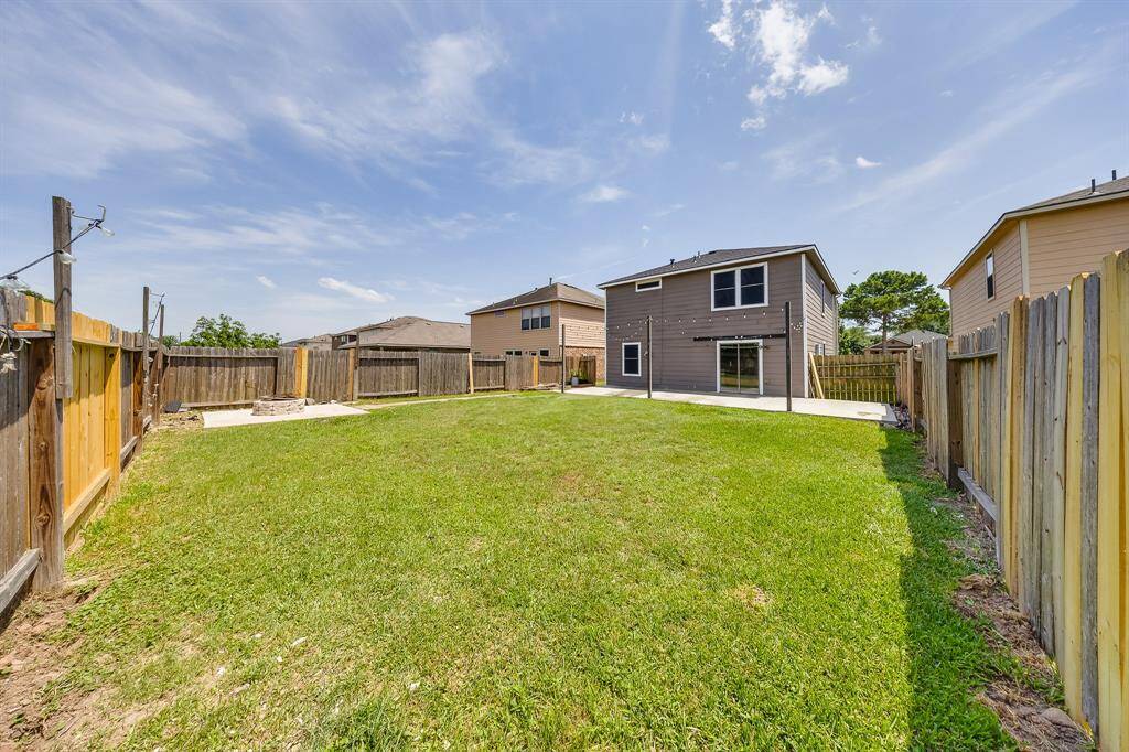 Direct access from the kitchen to the patio deck enhances indoor-outdoor flow for easy entertaining.