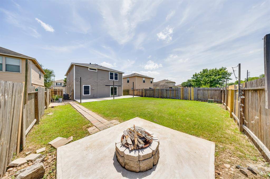 Cozy firepit in the backyard creates a warm gathering spot for relaxing evenings outdoors.