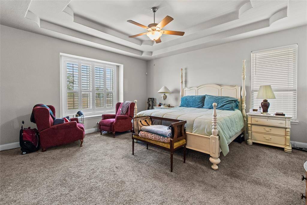 Enter the oversized primary bedroom with coffered ceilings and great view of the lake!