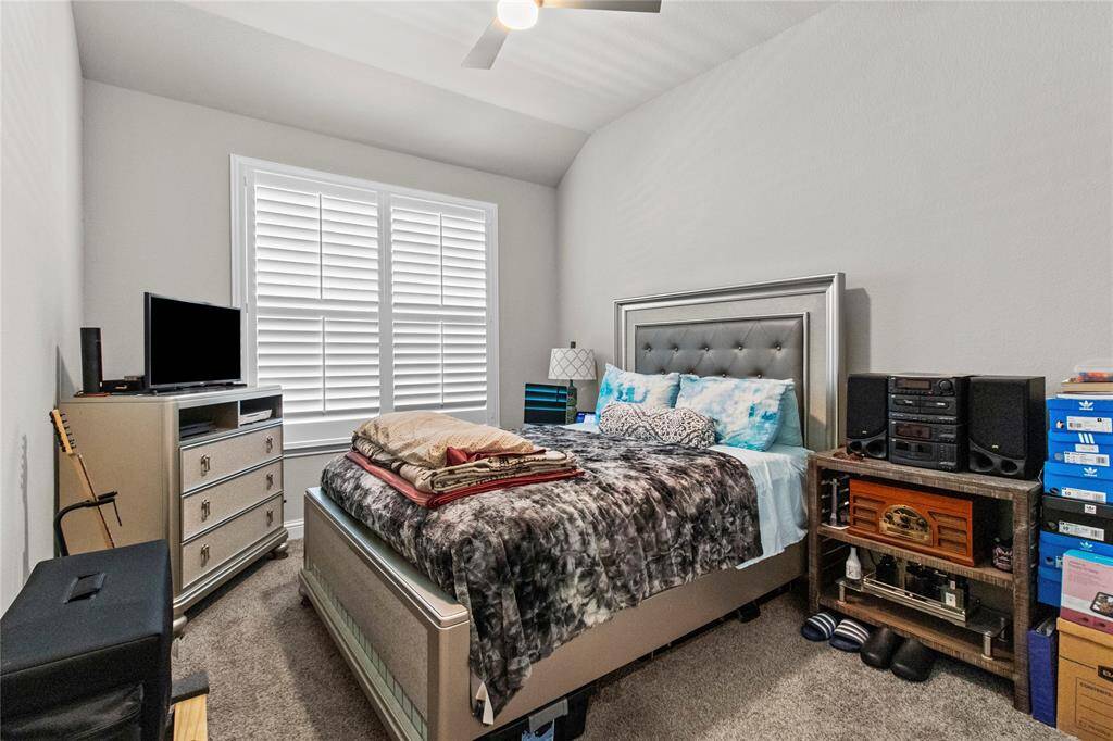 Guest bedroom one with blinds & ceiling fan