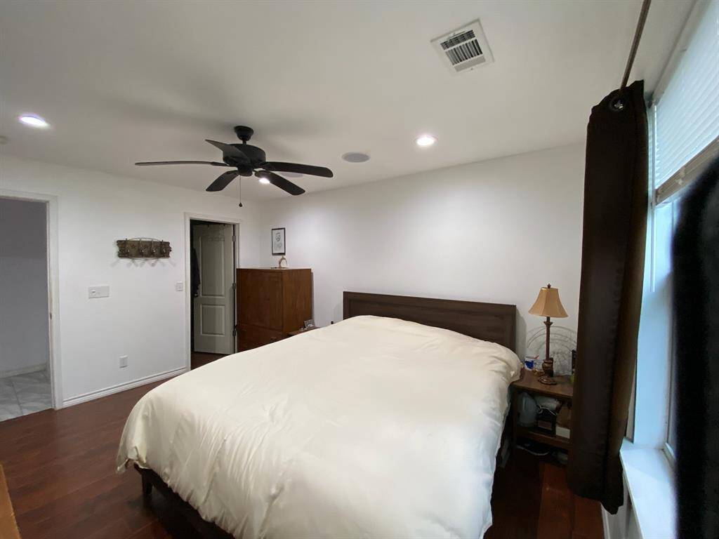 Nice sized primary bedroom with wood engineered flooring and walk-in closet