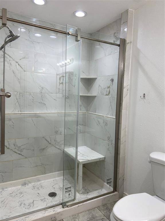 High end sliding glass doors in this updated primary shower