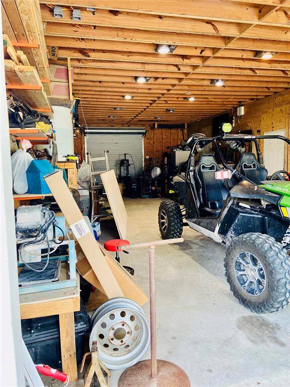10’ ceilings in the garage. Notice the metal roll up door in the back giving access from the front to the back of the garage.
