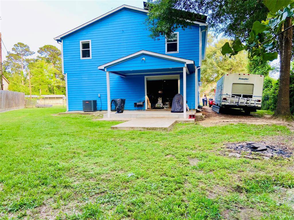 Another view of the back yard and house and the extra concrete pad.Large back yard.