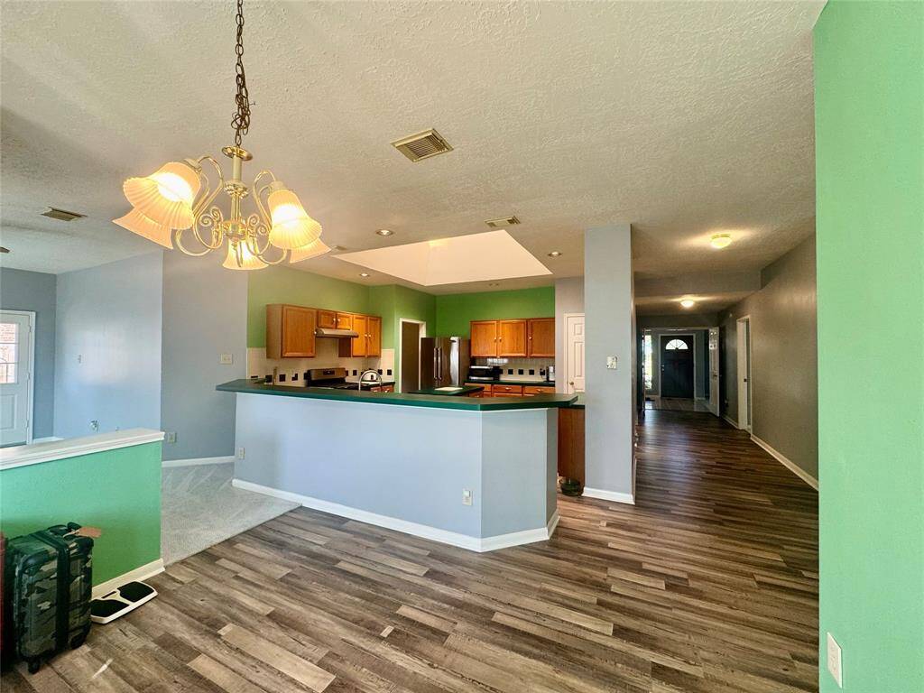 Breakfast room looking towards entrance, kitchen and entrance to family room.
