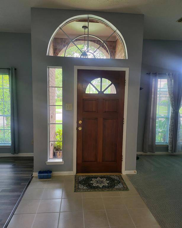 Grand entrance with Den/Formal living room on one side and Formal dining on other.