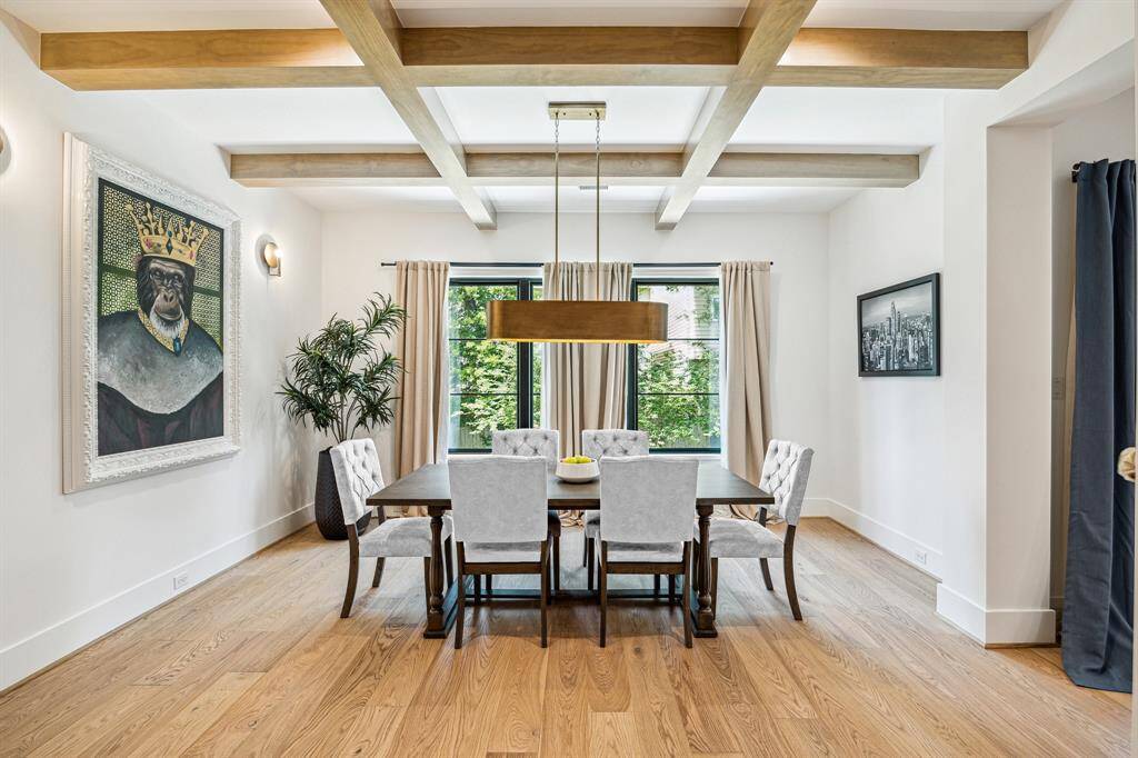 Dining room features exposed wooden beams.