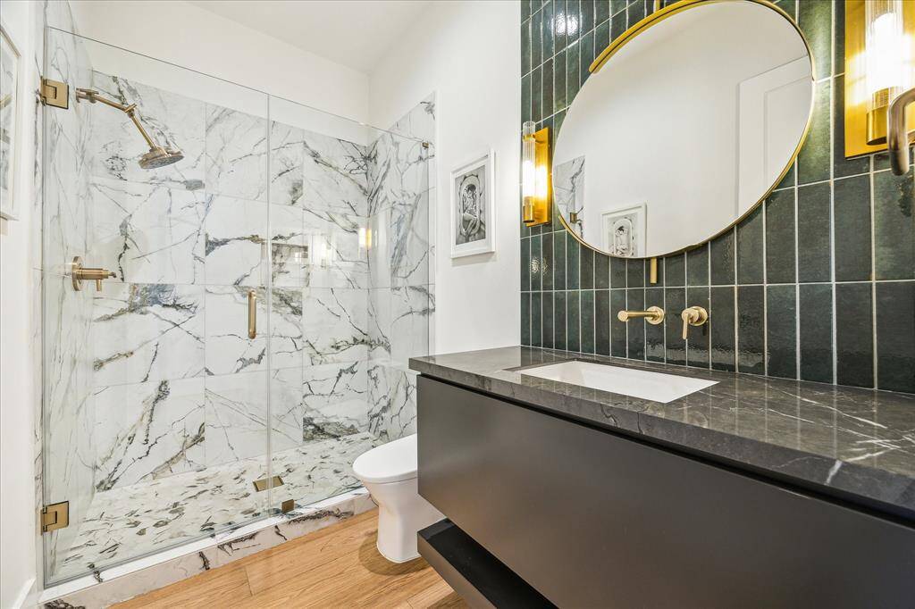 First-floor bathroom featuring a frameless glass-enclosed walk-in shower.