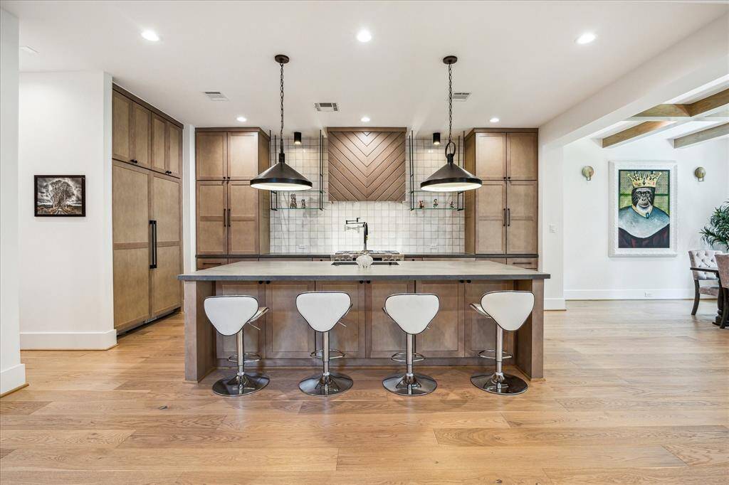 Kitchen is open to living and dining area and features modern finishes.