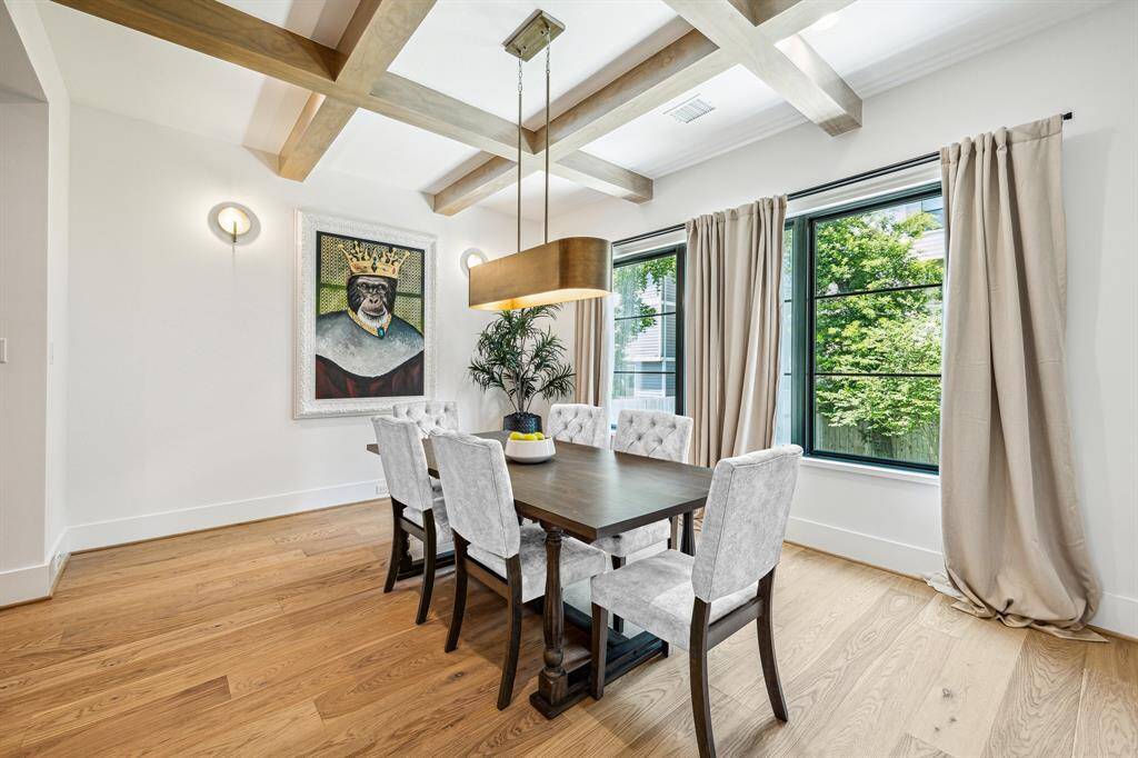 Spacious dining room with stylish chandelier.