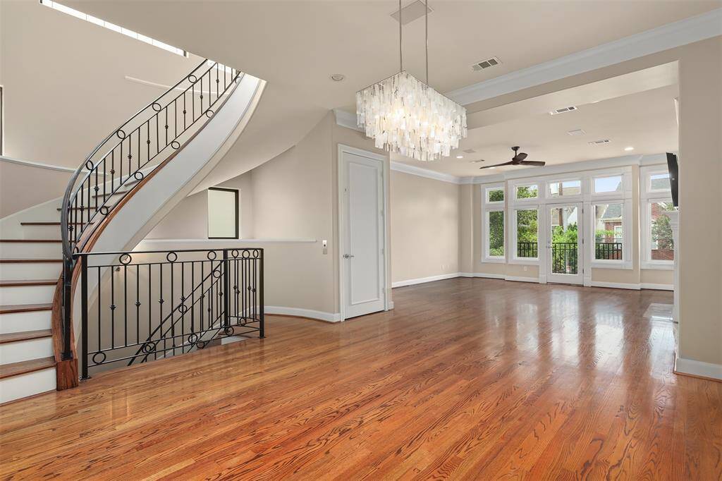 Spacious open-concept living and dining area.  One of the three tv’s included