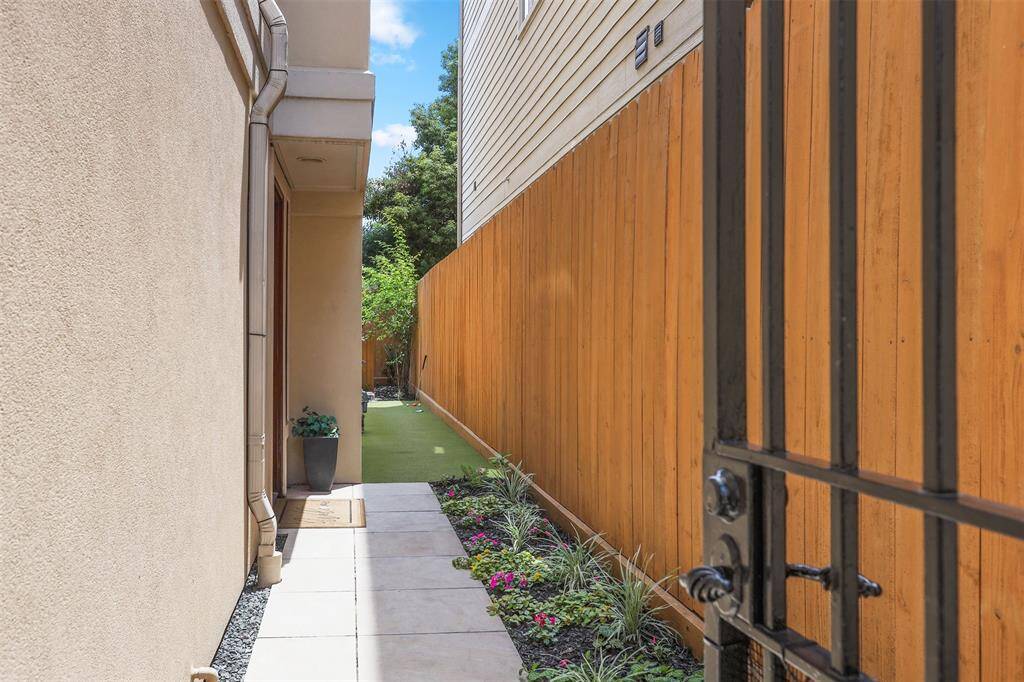 Private entrance with a neatly landscaped garden and a paved walkway