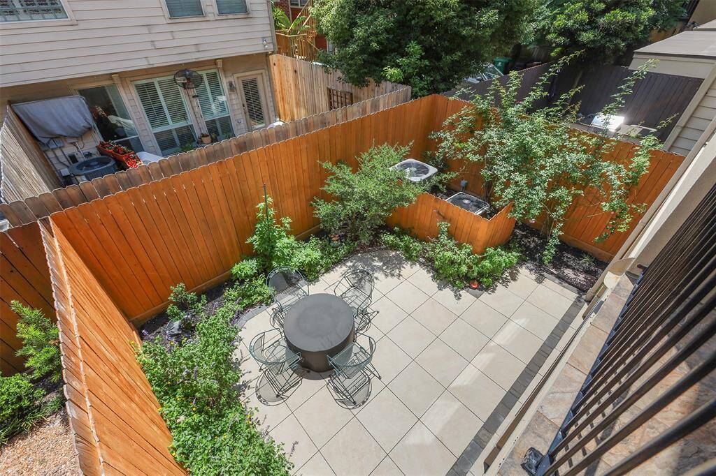 Elegant dining area with stunning hardwood floors and a graceful staircase backdrop.
