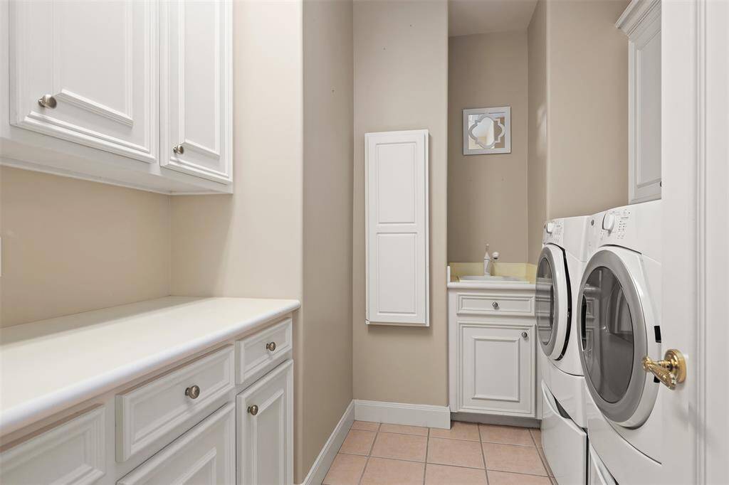 Spacious primary bedroom featuring elegant crown molding, a stylish tray ceiling..