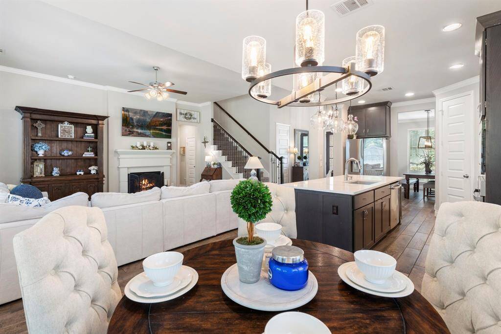 This open-concept view captures the breakfast area, living room, kitchen, and formal dining room, showcasing the home's spacious layout and seamless flow.