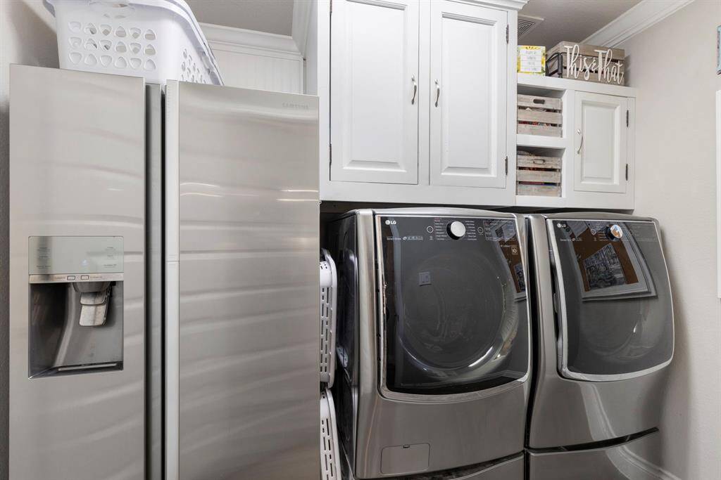 The utility room offers room for a second refrigerator and has lots of storage space for all of your cleaning supplies.