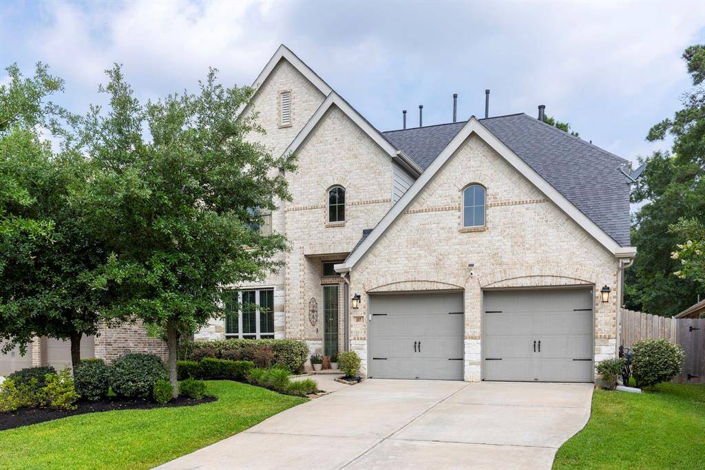 The double-wide driveway leads to the 2-car garage, providing ample parking and easy access to the home.