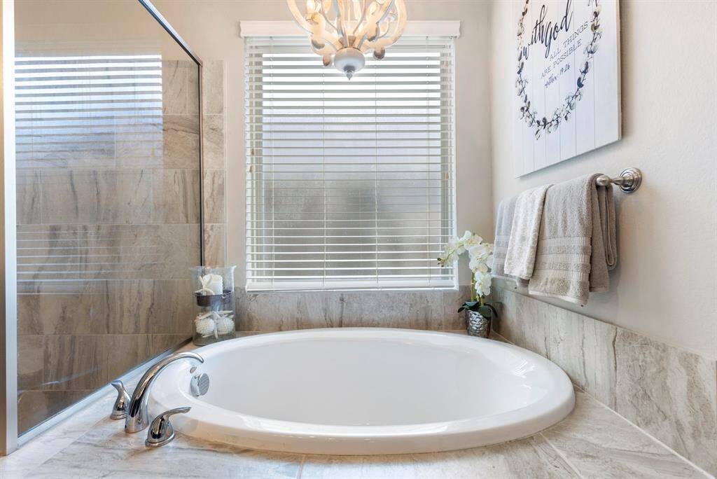 Enjoy a moment of peace in the large soaking tub, perfect for relaxing and unwinding after a long day.
