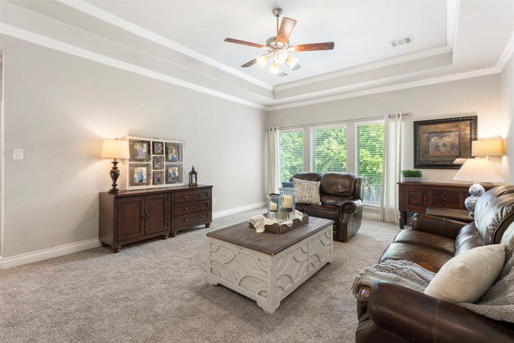 The large game room features soaring ceilings, crown molding, and endless possibilities for fun and function-whether it's a media space, playroom, workout room, or home office.