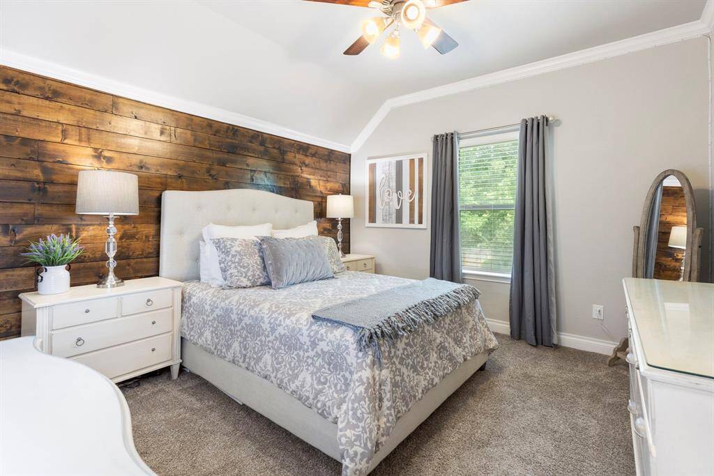 Second upstairs bedroom offers room for a desk and complete bedroom set, accented by a stylish shiplap accent wall.