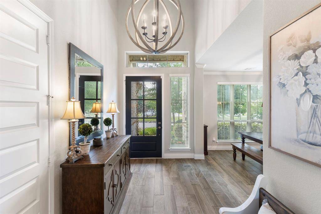 The grand entryway offers soaring ceilings and elegant lighting, setting the tone for the rest of the home.