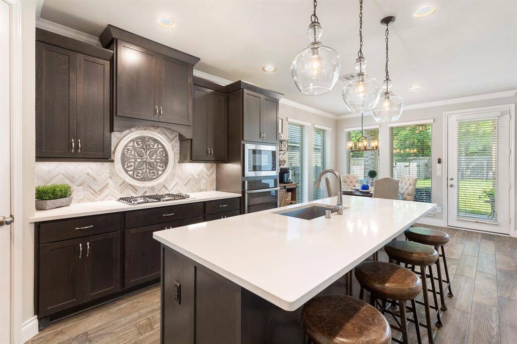 The kitchen is perfectly situated next to the breakfast area, where large windows offer an abundance amount of light.