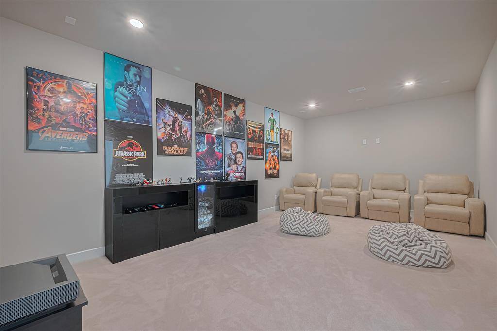 This is a cozy home theater room is ideal for movie or sports enthusiasts.