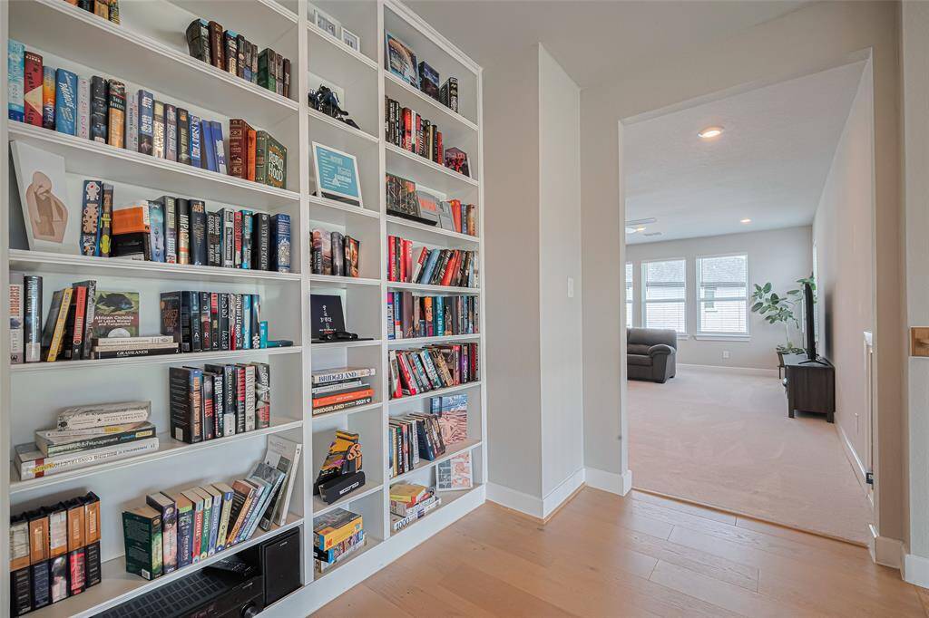 Built-in bookshelves make a smart use of space in upstairs hallway just outside the game room.