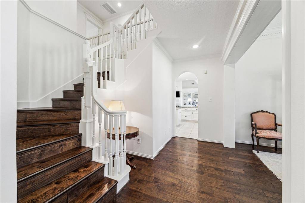 Beautiful wood floors great you at the front door, to the dining room and up both stairways.