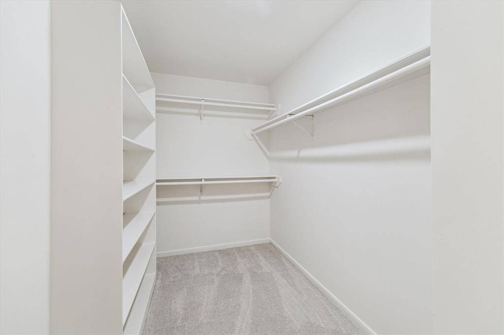 Just look at this huge walk in closet in a secondary bedroom.