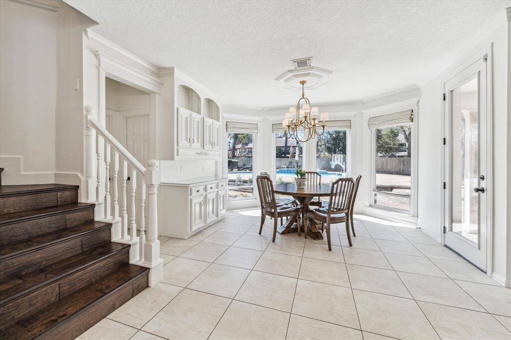The large breakfast nook can host a large table also.  Look at the built in butler's pantry.  Just through the door on the left is a half bath, the door to the right takes you out to  1 of the covered patios.