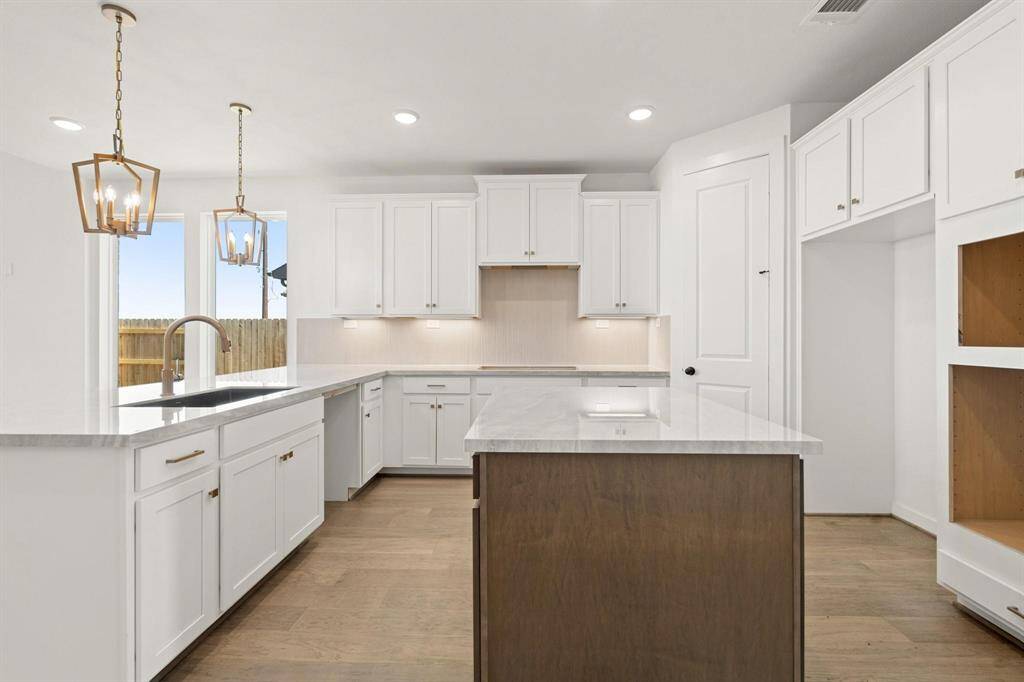 Porcelain counter tops, designer pendent lamps and built in appliances