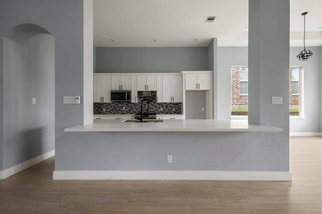 Open concept kitchen opens to living room & dining area