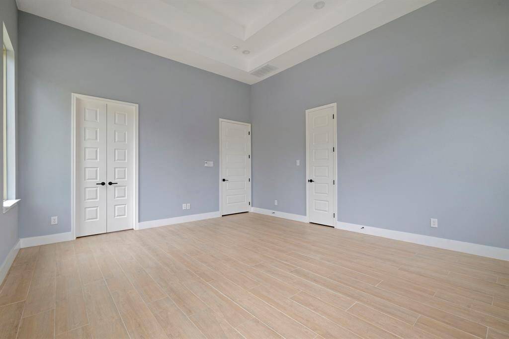 Primary bedroom features his and her closets