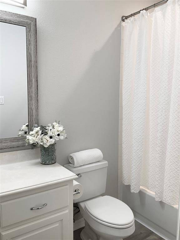 Bathroom number 2 again offering a clean, modern design with a light color palette. It includes a vanity with a large framed mirror, New light fixtures, and a tub shower combination.  This 2nd bathroom also serves as your guest bath located off the family room and home office.