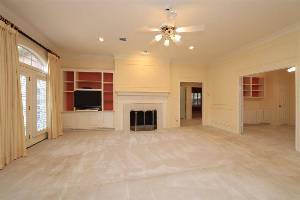 Enter the generously proportioned family room, perfect for gatherings and relaxation. Beyond the fireplace, tucked away for privacy, discover your own serene primary bedroom featuring a spa-like primary bathroom, creating a  retreat within your home.
