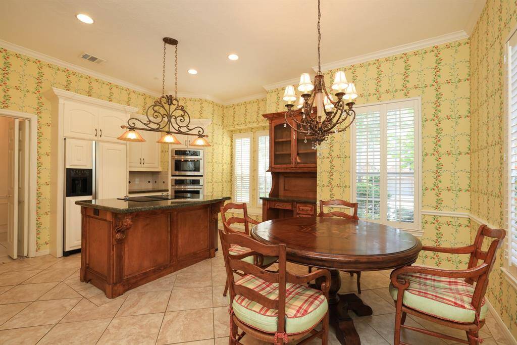 The heart of the home is a granite kitchen, where culinary enthusiasts will delight in good counter space, stainless steel appliances, and custom cabinetry. Whether hosting dinner parties or preparing family meals, this kitchen is sure to impress.