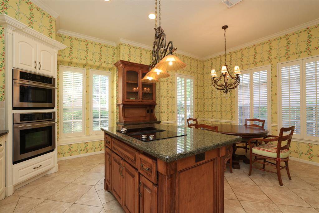 Enjoy a wall-in oven and microwave, classic shutters, and abundant natural light. Tile floors flow throughout, and a convenient door leads to your private backyard with no rear neighbors for added privacy.