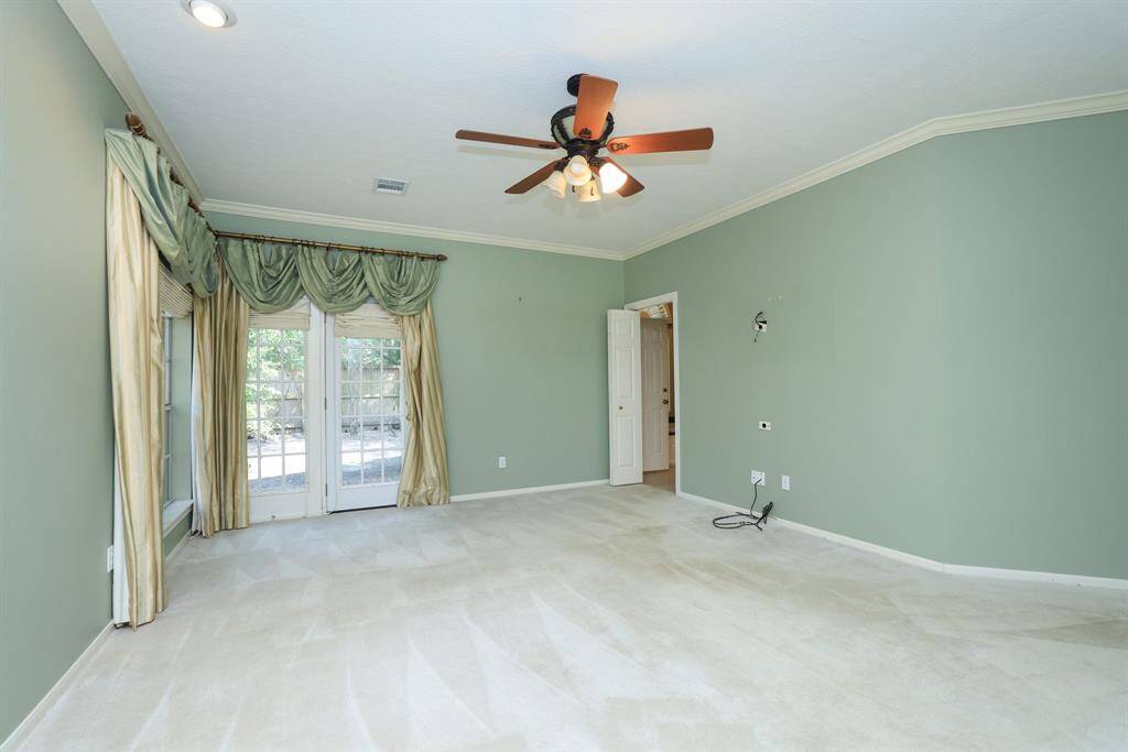 Take in the tranquil view of your backyard space from the comfort of your primary bedroom. Appreciate the serenity and peace this area provides, enhanced by the crown molding. NO BACK NEIGHBORS!