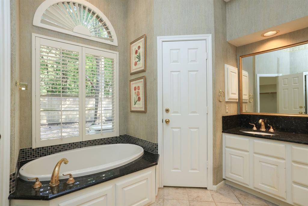 Experience the convenience of dual sinks in the primary bathroom, providing ample space for two. The countertops feature both upper and lower height sections, accommodating different preferences, and are complemented by drop-in sinks, combining functionality with a sleek design aesthetic.