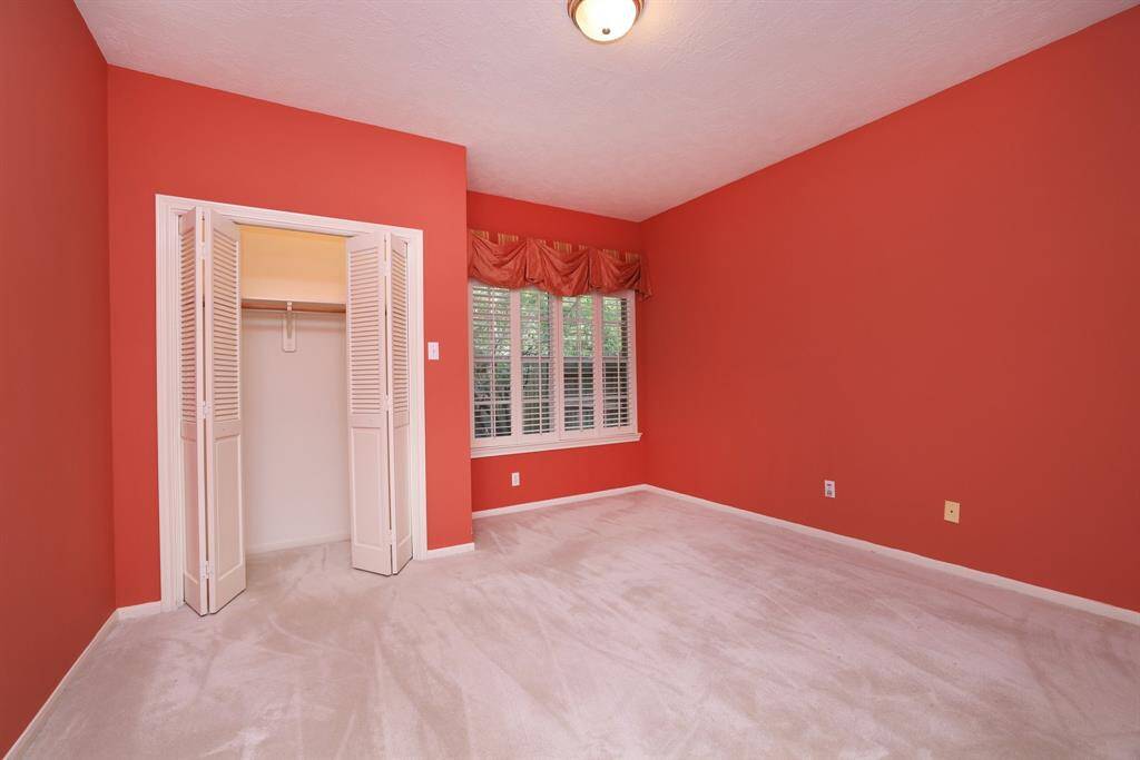 Secondary bedroom with nicely sized closet, and ceiling fan.