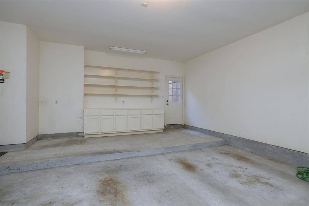 Attached 2-car oversized garage offers direct access to the atrium and features built-in cabinets and shelving for added storage. Includes a garage door opener and interior controls for the home’s lawn irrigation system.