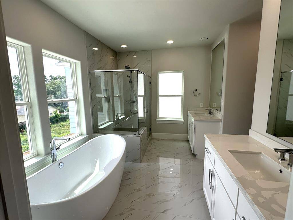 This Home Gets So Much Natural Light,look at the Primary Bathroom - Free Standing Tub, Split Vanities and Seated Shower