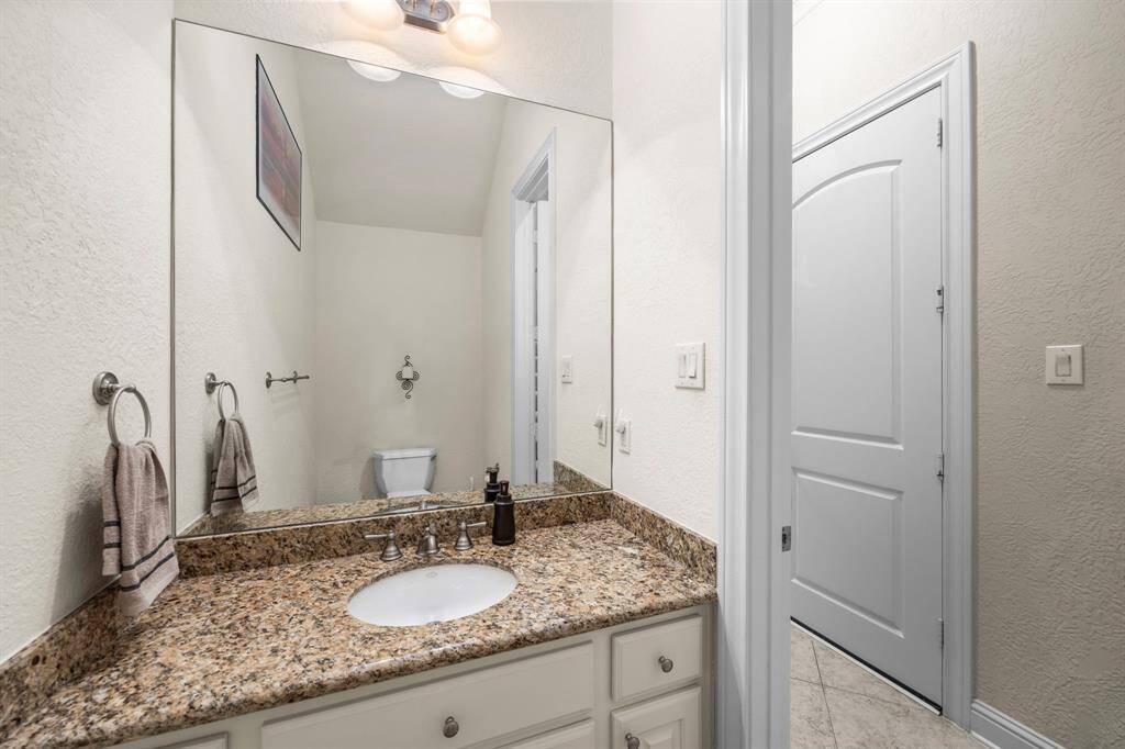 The half bath downstairs is strategically placed away from entertaining areas near the stairs.