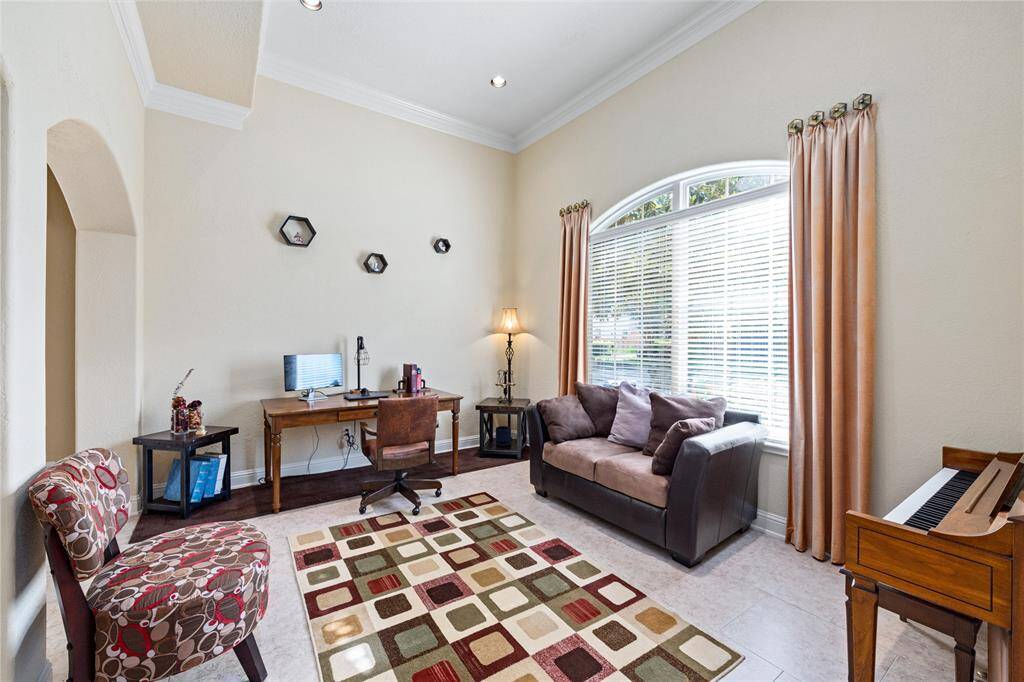 This spacious flex area is currently serving as a home office & overlooks the front yard but could easily be used as a formal living or lounge space.