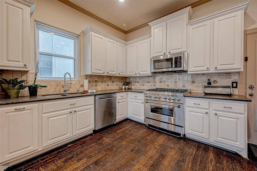 This updated kitchen is well-lit, featuring modern fixtures and plenty of natural light to create a bright and inviting space.